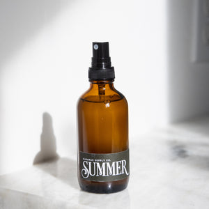 summer room spray bottle on a white marble counter