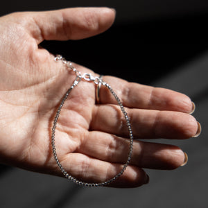 hand holding a single smoky quartz seed bead bracelet