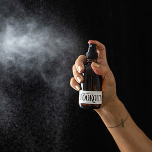 Lookout Room Spray mist in front of black wall