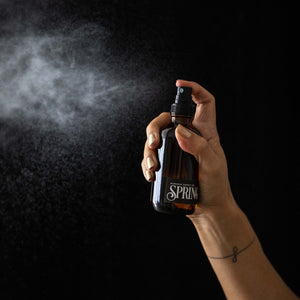 spring room spray mist on black background