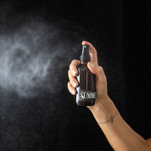 Summer Room Spray mist in front of black background