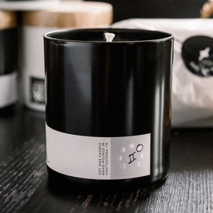 10z candle tumbler with label showing the moon phase and zodiac sign it was created under