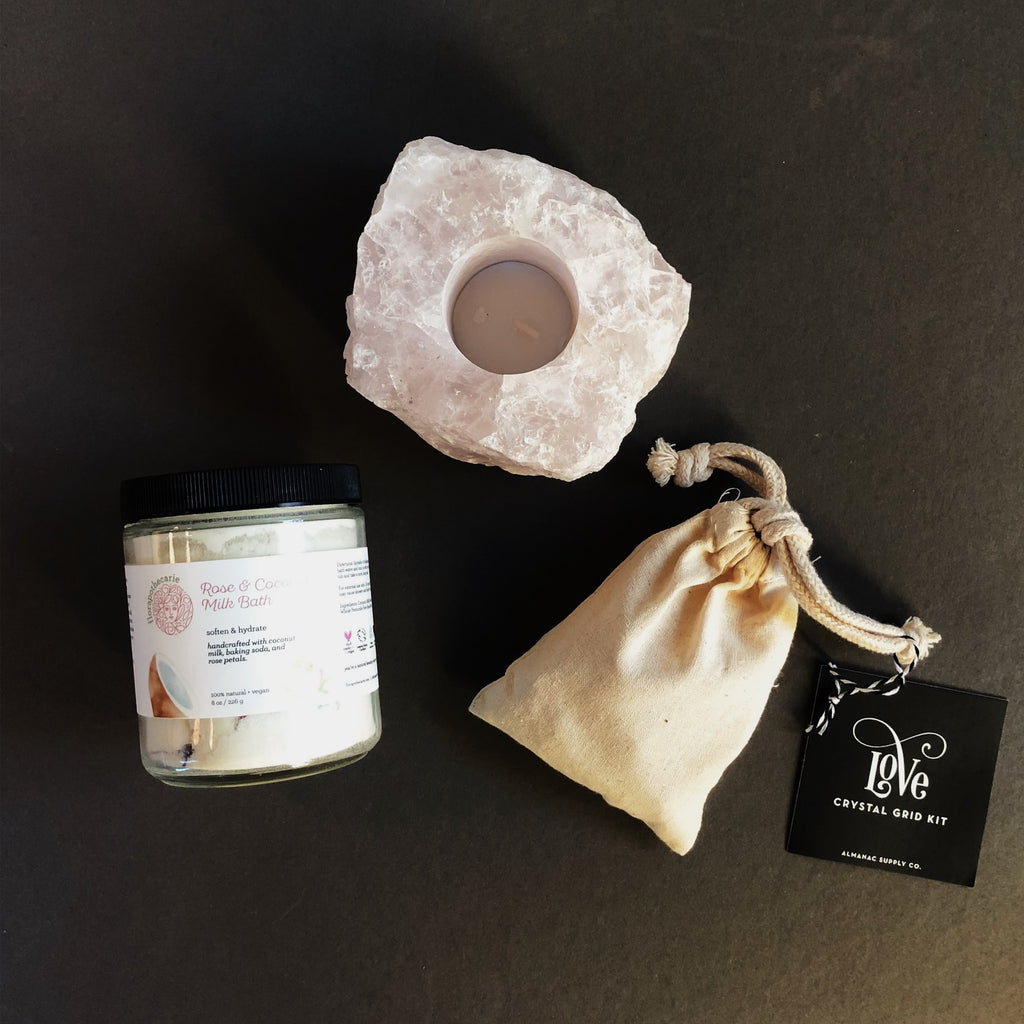 Bundle of love with a Rose Quartz candle holder, rose and coconut powdered milk bath, and love crystal grid kit.