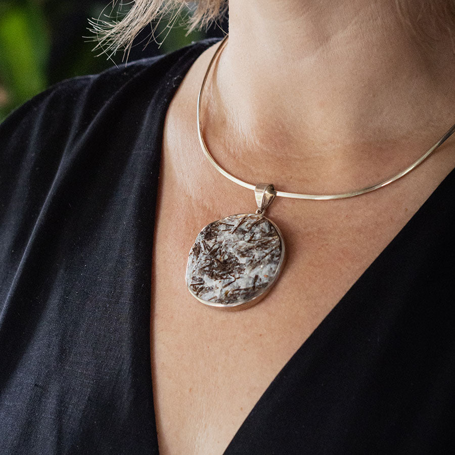 Black and white crystal pendant on silver collar necklace