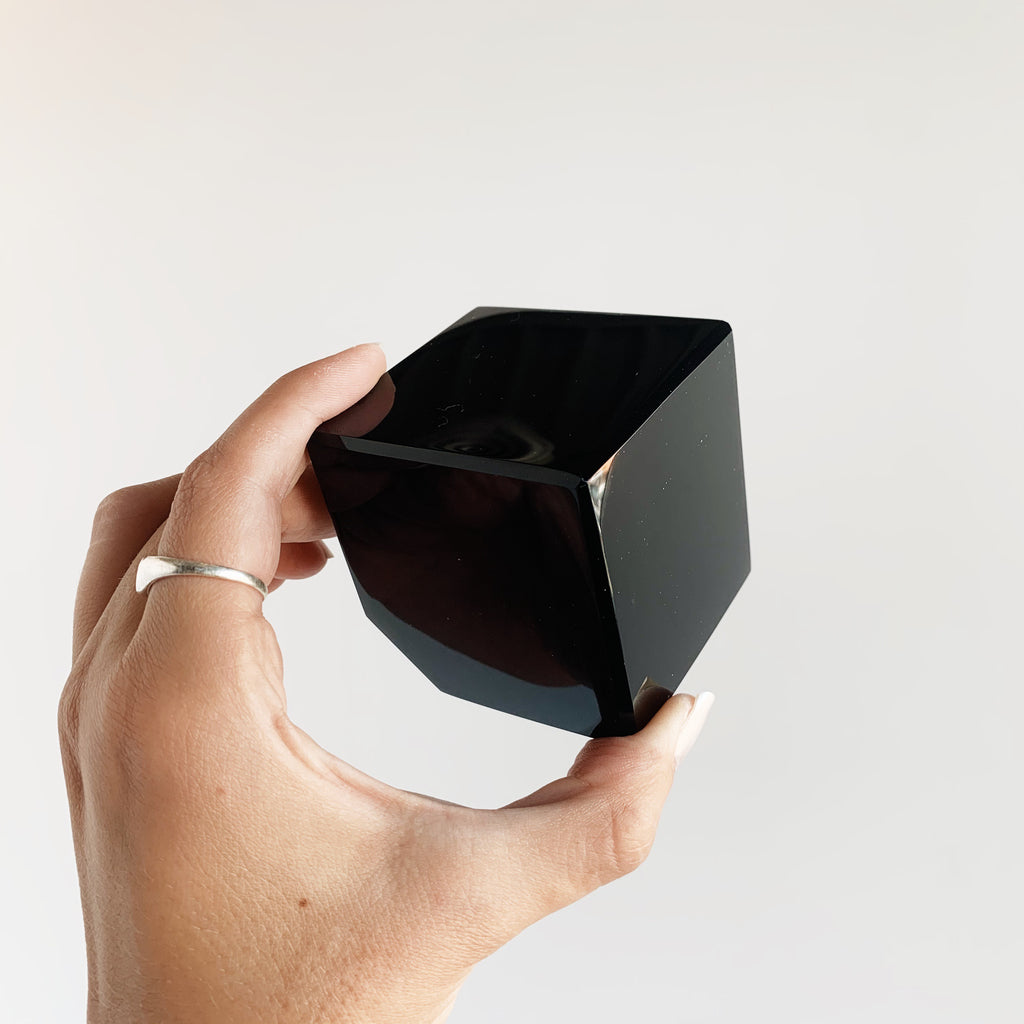 Hand holding an Obsidian cube
