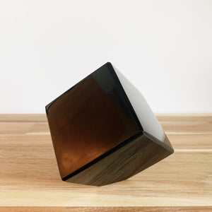 Obsidian cube on a wooden table