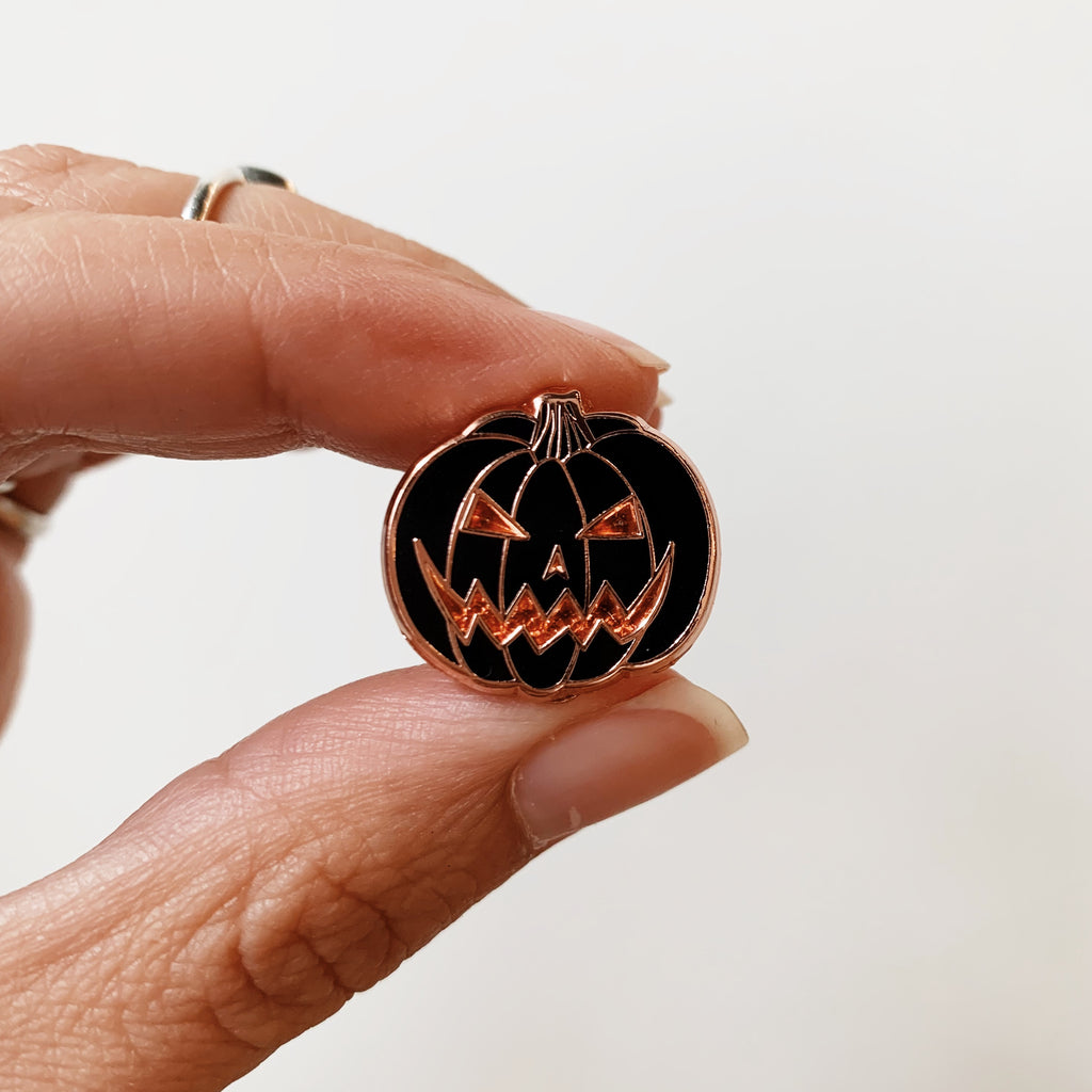 Orange and black jack-o-lantern enamel pins