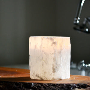 Lit candle inside a Selenite candle holder