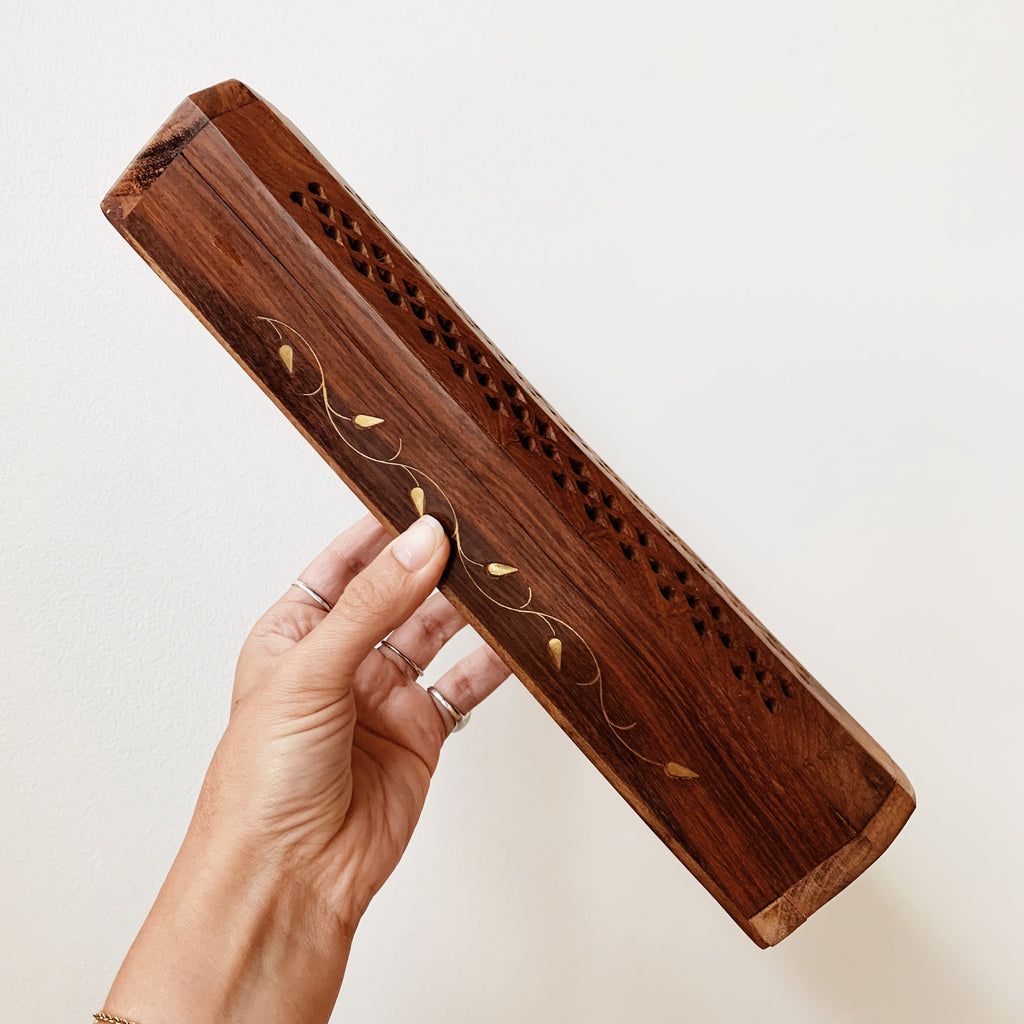 Closed wooden incense box with golden vine inlay